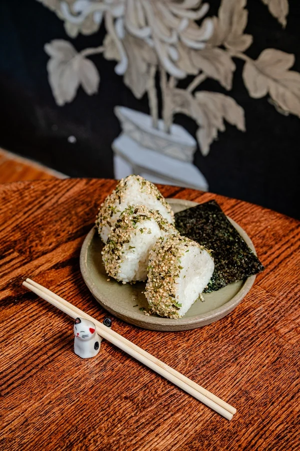 Sesame-crusted onigiri with nori on a ceramic plate at Bareo