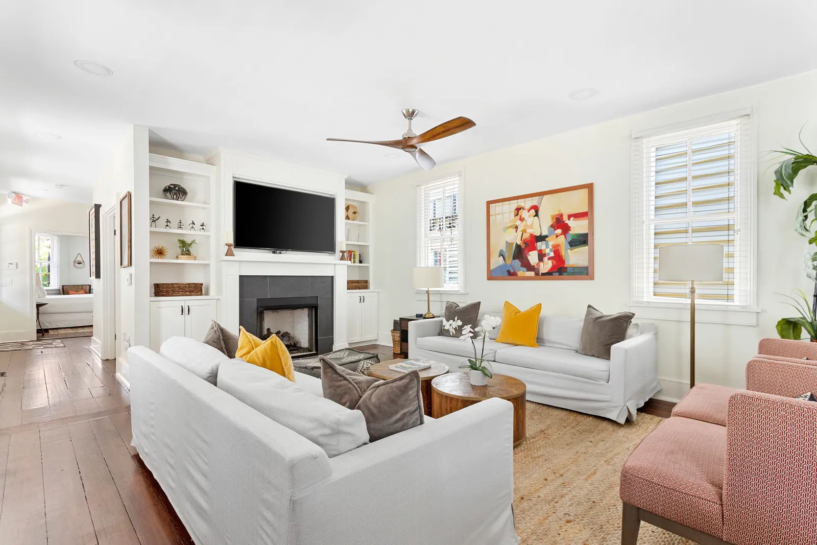 The living room fireplace with a 65 inch TV and built-in shelving