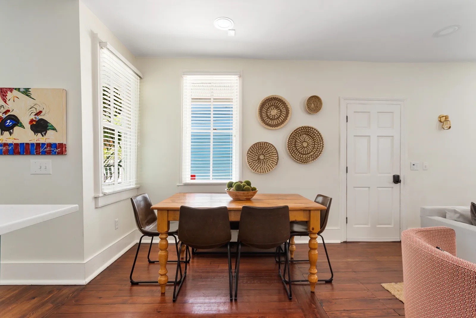The dining area with a farm table beside the living room