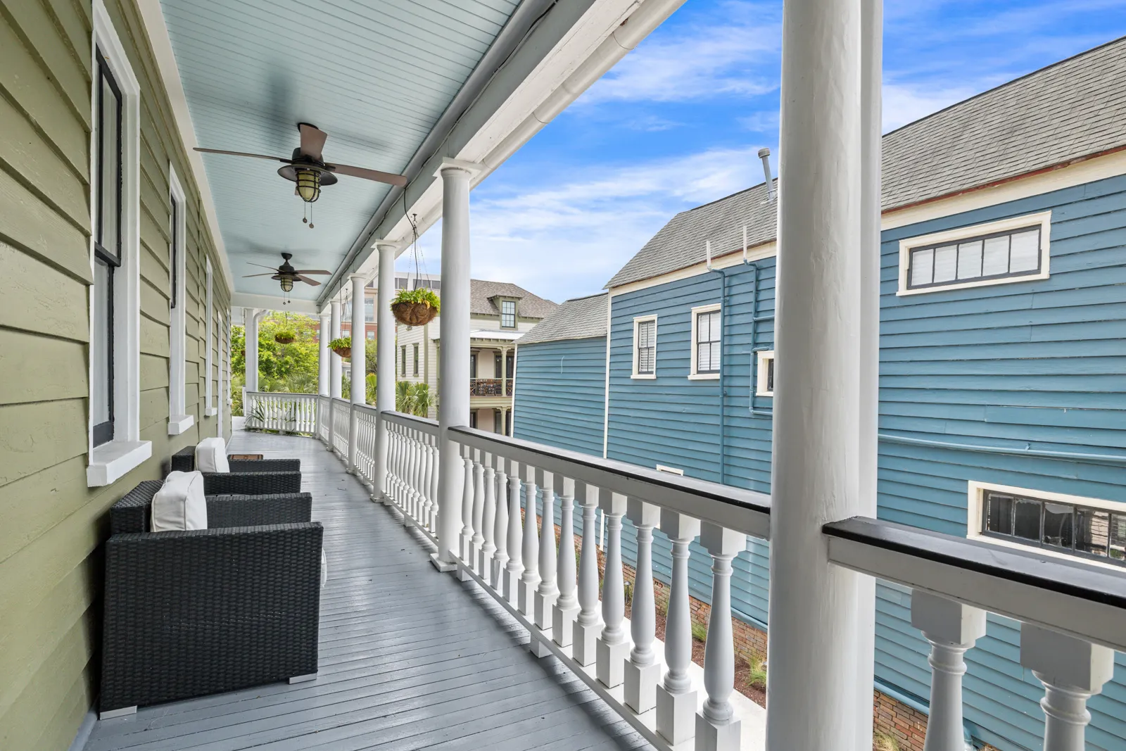The upper porch of The Mint Julep with seating overlooking Cannonborough