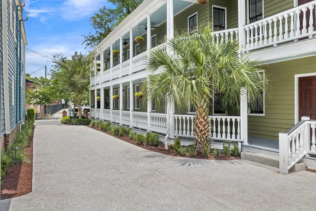 The side of The Mint Julep Residence with its double porches, palm and private drive