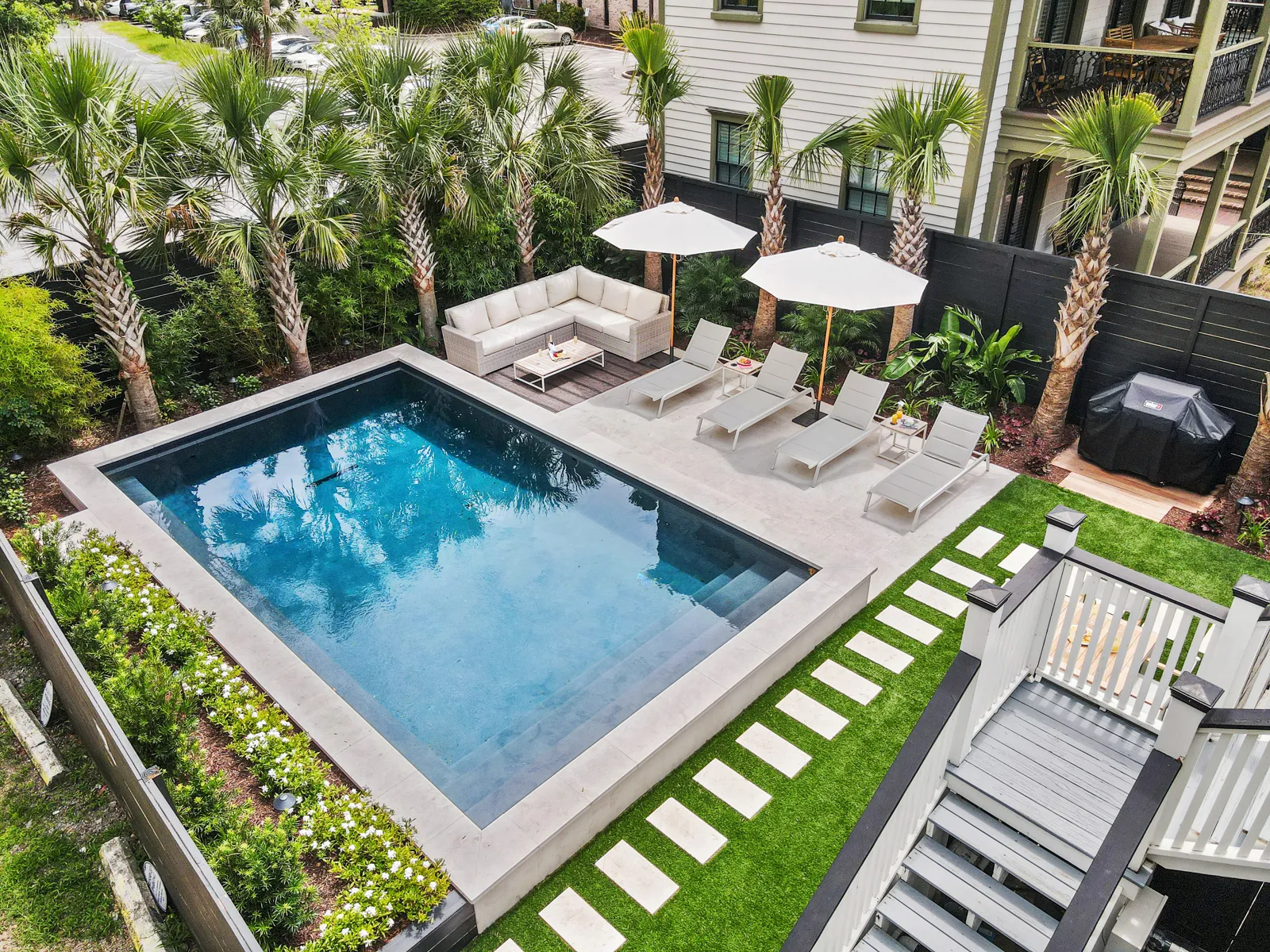 The Mint Julep Residence pool from above: the largest private pool in downtown Charleston, lined with sun loungers and palms