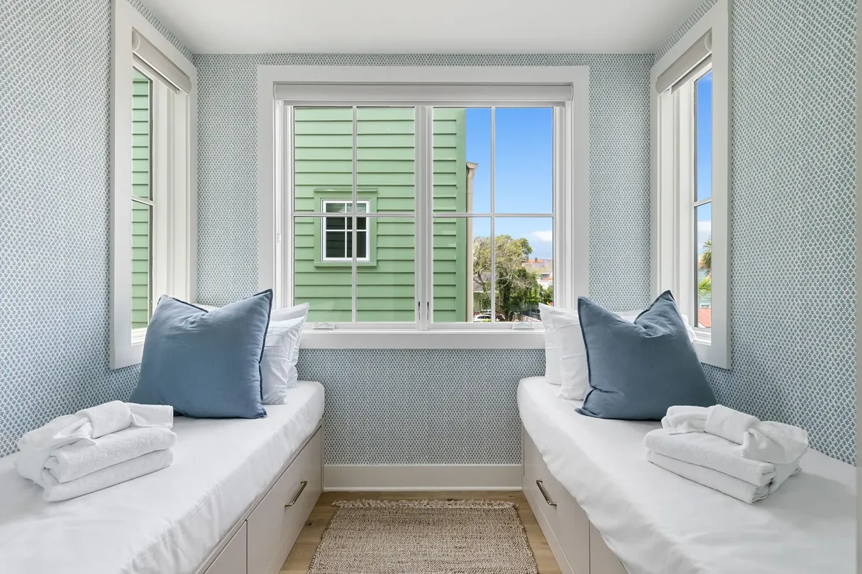 The kids' room with two child-size twin cot beds and blue pillows