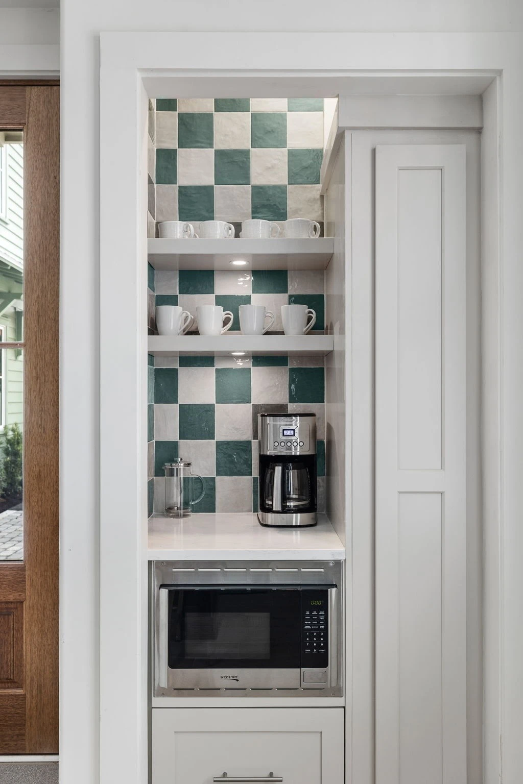 The coffee bar nook off the kitchen with green checkered tile