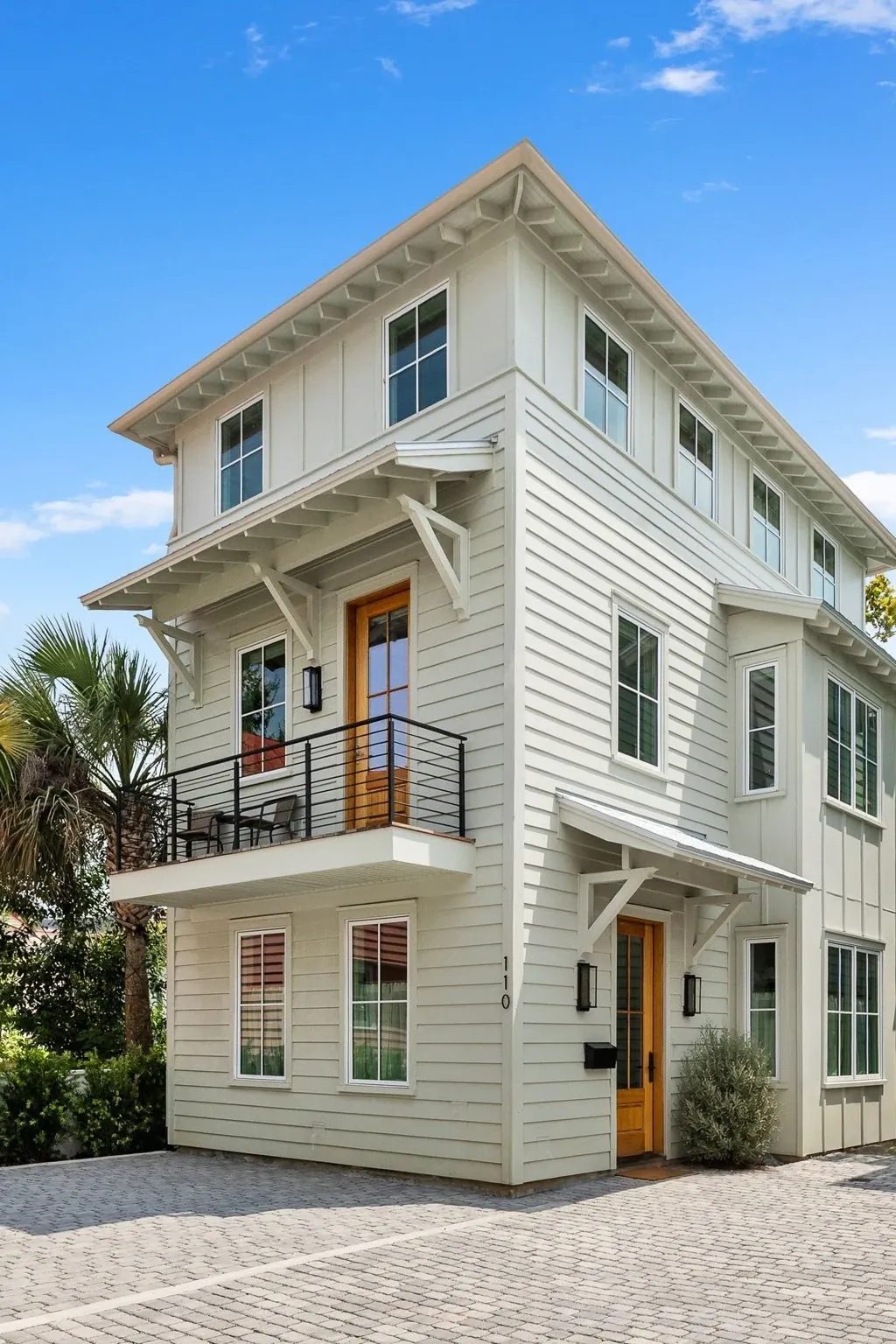 The 110 Signature Residence at Smalls Alley, three stories tall off the paver courtyard