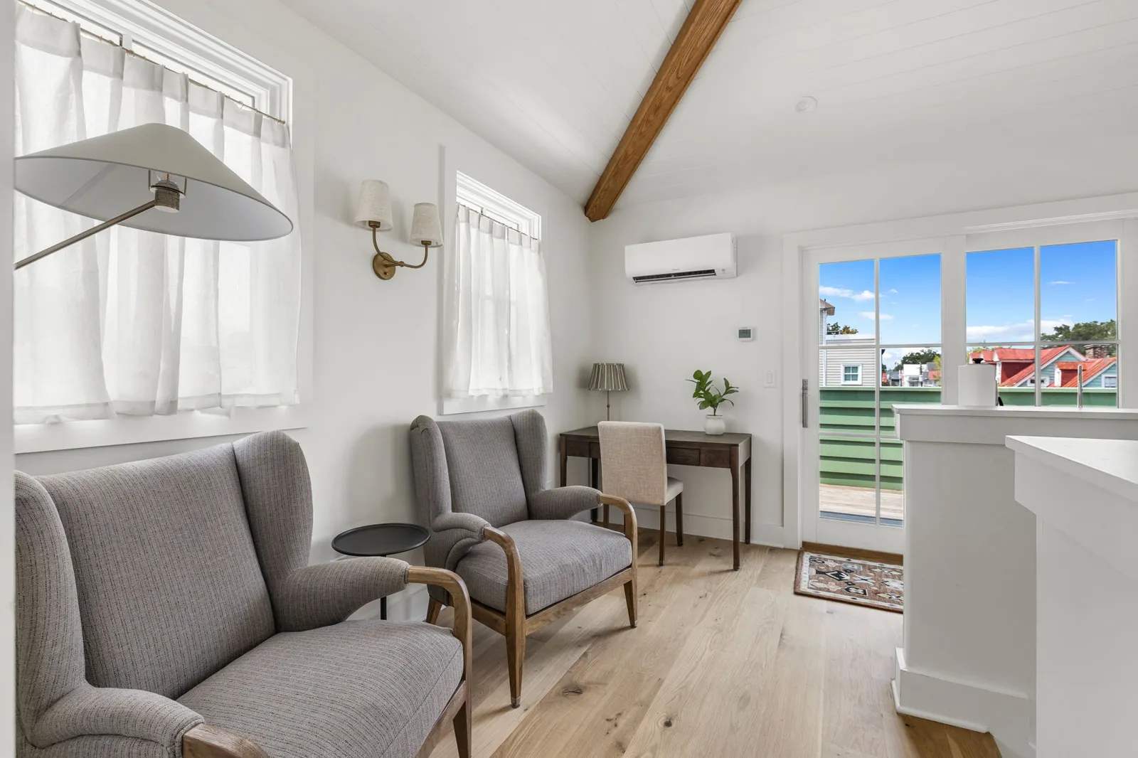 The third floor primary suite lounge with the rooftop deck just outside